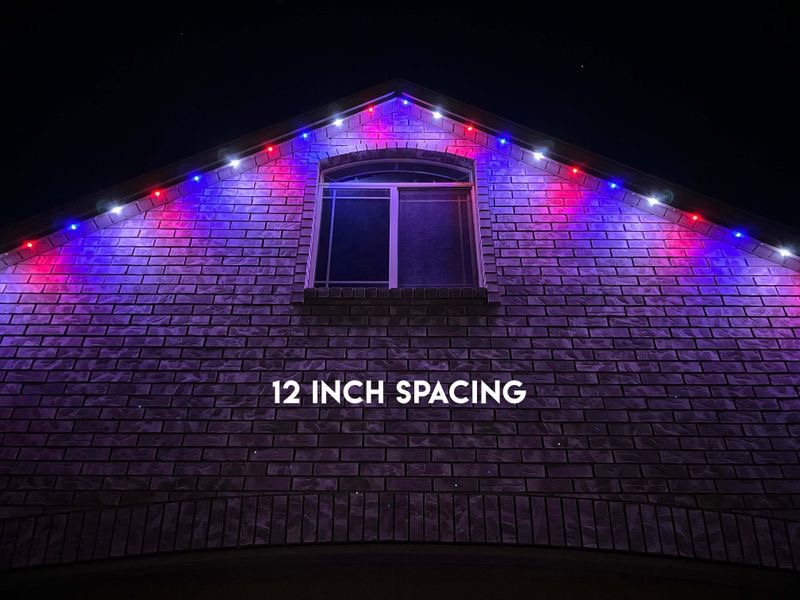 Roofline lit with InvisiLights permanent lighting at 12 inch bulb spacing at night