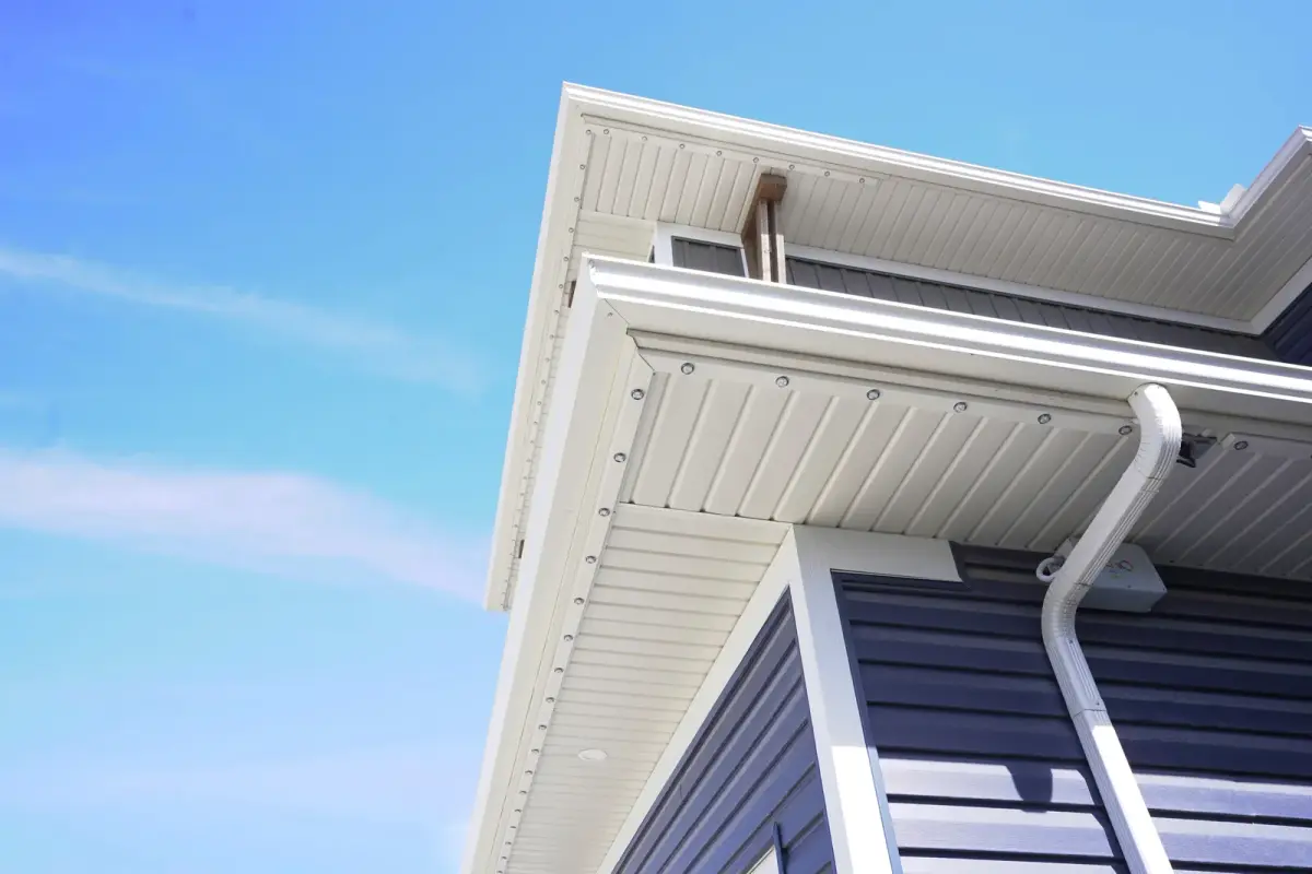 Close up of permanent lighting track and lens tucked into a white soffit