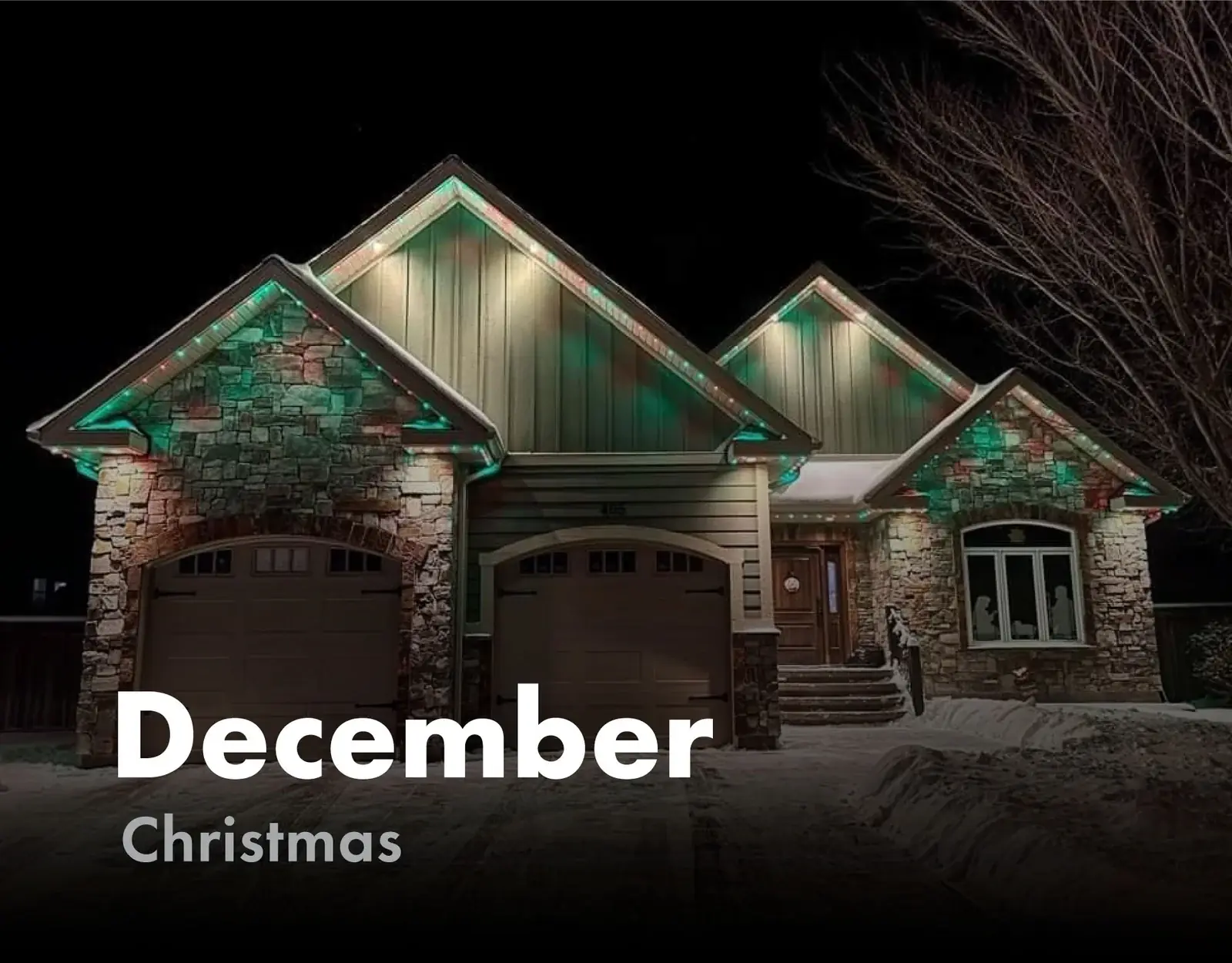 Snow covered home lit in red and green for Christmas in December