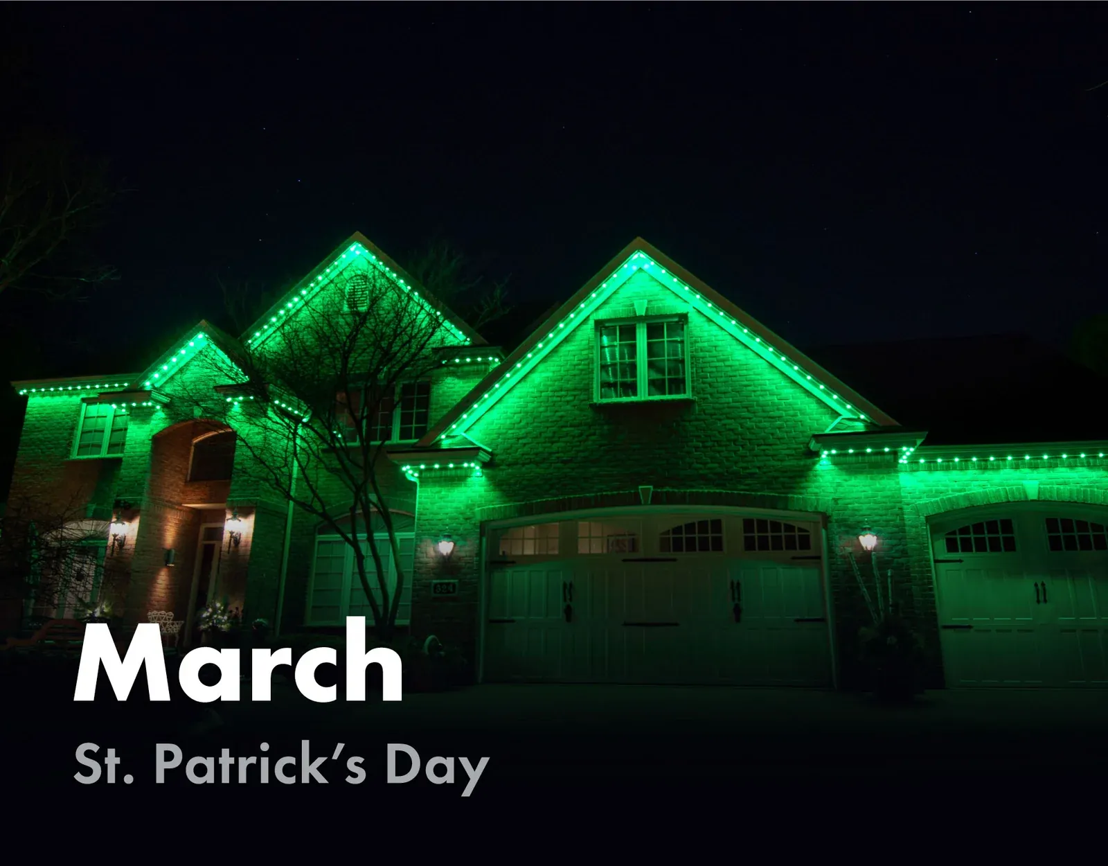Home roofline lit in green for St. Patrick's Day in March