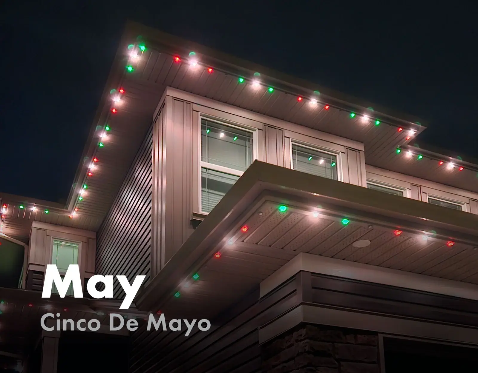 Home roofline lit in red, white and green for Cinco De Mayo in May